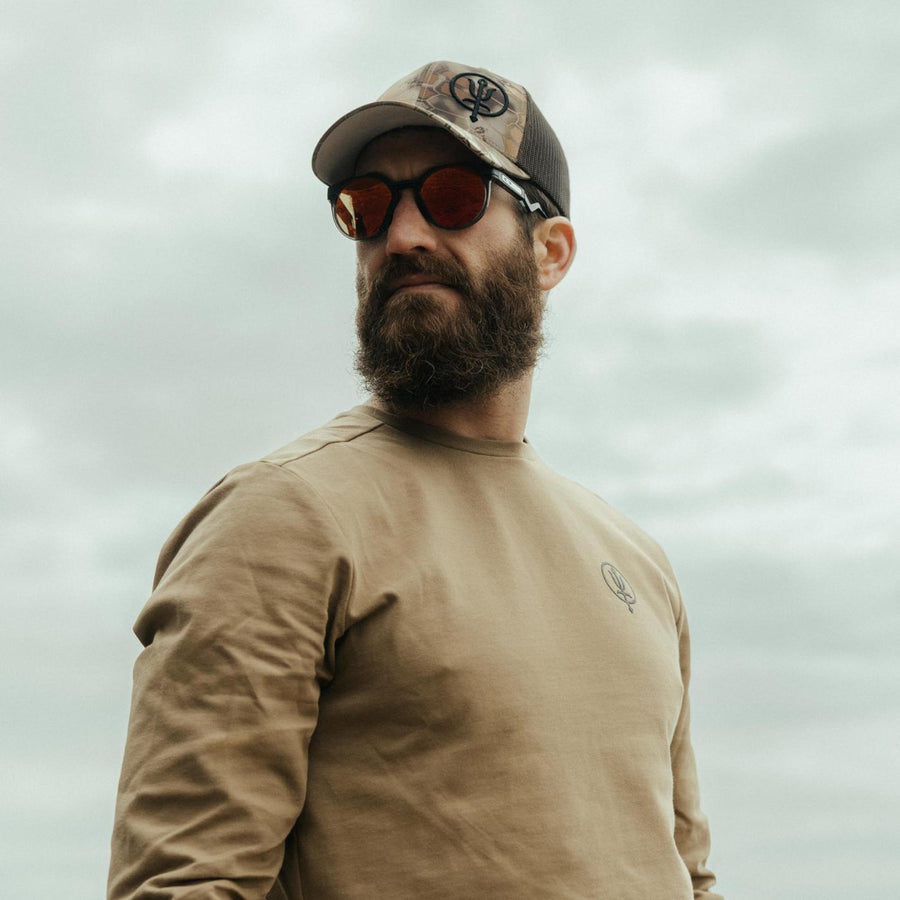 Louis Tinsley wearing the Kryptek Cap with a Long Sleeve Insignia T-Shirt and sunglasses.